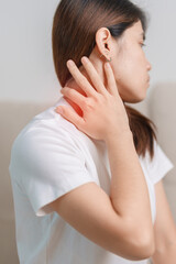 Woman having Neck and Shoulder pain during sitting on couch at home. Muscle painful due to Myofascial pain syndrome and Fibromyalgia, rheumatism, Scapular pain, Cervical Spine. ergonomic concept