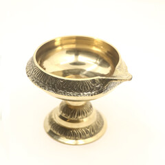 handcrafted brass oil diya lamp with stand used for decorative fire light in hindu festival and ceremony isolated in a white background