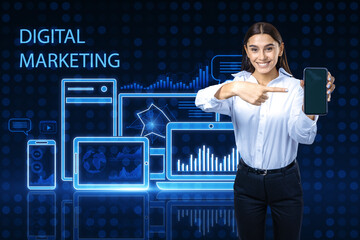 Attractive happy european businesswoman pointing at smartphone on blue pixel background with...