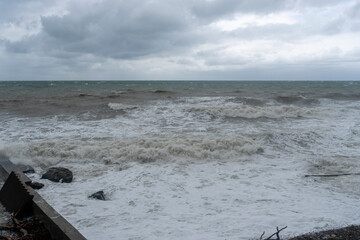 storm on the black sea, waves crashing on the shore, brown water