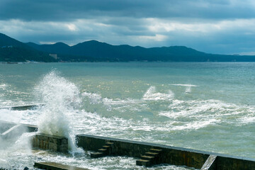 small storm on the sea, waves hitting the shore