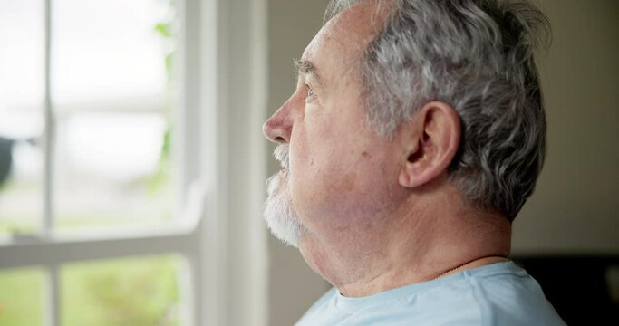 Senior man, anxiety and thinking on retirement, stress and worry by window for future. Elderly male person, depression and nervous for nursing home, fear and doubt or regret for decision and lonely