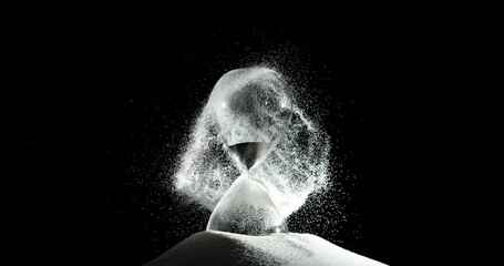 Hourglass add more sand of time on white sand over black background. White hourglass show more time...
