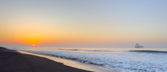 Beautiful sunrise over the black sand beach of Port of San Jose in Guatemala
