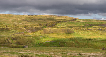 Fototapeta premium ruined buildings at Groverake Mine, in the North Pennines Area of Outstanding Natural Beauty (ANOB), near Allenheads, Durham, UK
