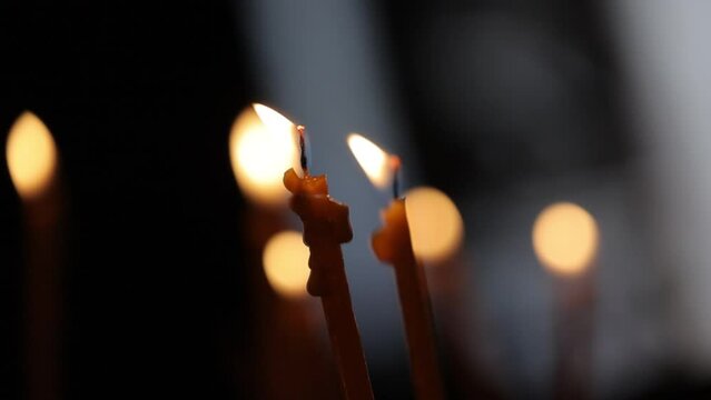 Close up footage of candles of prayers in a church with blur background