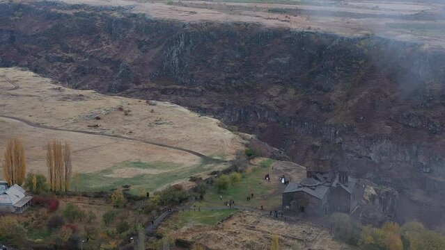 Aerial view of Saghmosavank monastic complex at the top of Kasagh gorge on a foggy morning, Armenia