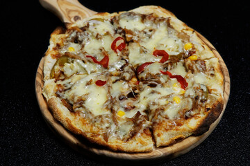 baked flat bread known as italian pizza, with black background