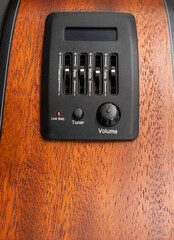 Pickup and tuner of guitar, close up shot, bass, middle and treble zone to tune sound , build on mahogany guitar side wood