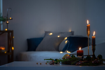 burning candles with christmas decor in white cozy interior - obrazy, fototapety, plakaty