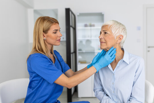 Endocrinologist examining throat of senior woman in clinic. Women with thyroid gland test . Endocrinology, hormones and treatment. Inflammation of the sore throat