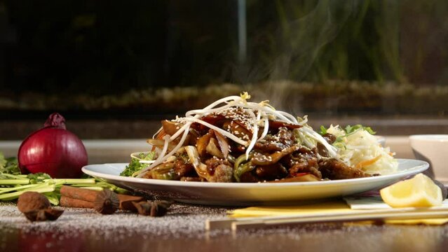 Crispy beef emits steam in authentic Chinese kitchen.