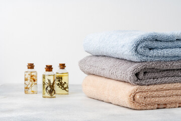 Organic essential aroma oil with herbs and towels, spa concept