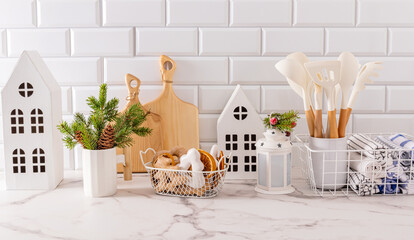 Beautiful New Year kitchen background in white tones with kitchen utensils and modern decor elements for New Year and Christmas.