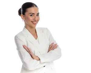 beautiful woman in white suit crossing arms and smiling