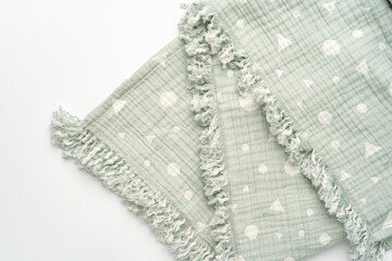 Green muslin blanket for kids on white background
