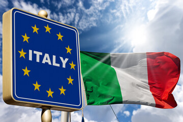 Closeup of a modern Italian border road sign with the Italian and European Union flag, against a blue sky with clouds and copy space. Schengen agreement.