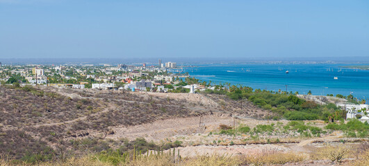 Fototapeta premium View of the bay, from the hill in the city of La Paz with mountains, city, sea and the mogote. Sunny summer morning, Baja California Sur, MEXICO
