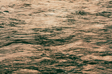 The surface of the water in the river at sunset