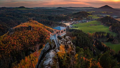 Jetrichovice, Czech Republic - Aerial panoramic view of Mariina Vyhlidka (Mary's view) lookout at sunset with foggy Czech autumn landscape and colorful sky in Bohemian Switzerland region - obrazy, fototapety, plakaty