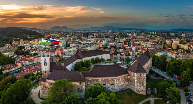 Fototapeta Ljubljana, Slovenia - Aerial panoramic view of Ljubljana Castle on a summer afternoon with Franciscan Church of the Annunciation, Ljubljana Cathedral and skyline of the capital of Slovenia at sunset