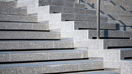 Outdoor concrete stair covered with rough granite tiles. Step of exterior stairway with stainless steel railing. Modern staircase design. Architectural element detail - obrazy, fototapety, plakaty