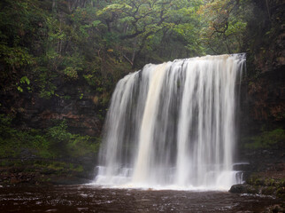 Waterfall Sgwd yr Eira on the four waterfalls walk in Brecon Beacons national park Wales UK - obrazy, fototapety, plakaty