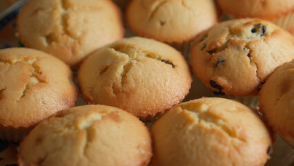 Golden delicious muffins prepared for a family dinner are on a plate. Close-up.