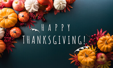 Thanksgiving and Autumn decoration concept made from autumn leaves, pumpkin and the text on dark background.