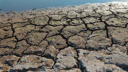 Eroded cracked soil after water has drained. Problems of global warming.