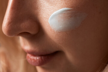 Close up beauty portrait laughing beautiful half naked woman applying face cream make up health spa...