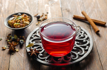 Herbal Tea, Hibiscus Red Tea in Glass Cup on Wooden Background, Autumn or Winter Drink