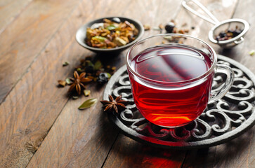 Herbal Tea, Hibiscus Red Tea in Glass Cup on Wooden Background, Autumn or Winter Drink
