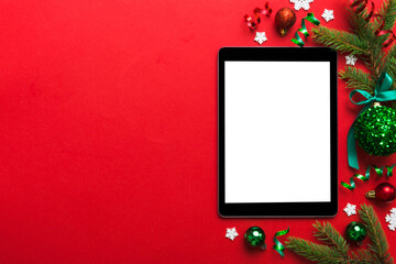 Digital tablet mock up with rustic Christmas decorations for app presentation top view with empty space for you design. Christmas online shopping concept. Tablet with copy space on colored background