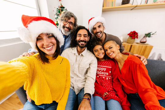 Happy family taking selfie portrait celebrating christmas together at home. Celebration and xmas concept.