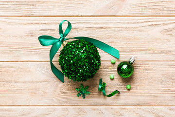 Christmas ball on colored background. decoration bauble with ribbon bow with copy space