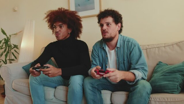 Two guys playing on games console together
