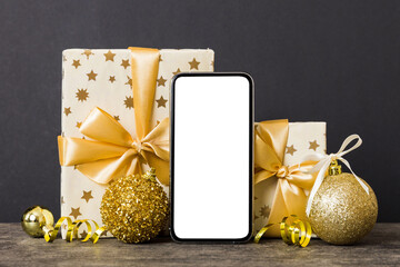 Digital phone mock up with rustic Christmas decorations for app presentation with empty space for you design. Christmas online shopping concept. Tablet with copy space on colored background