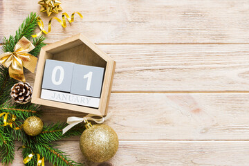 Christmas calendar 1 january. Christmas gift, fir branches, pine cones. Flat lay, top view. New Year decorations on a colored background - obrazy, fototapety, plakaty