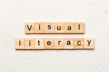 visual literacy word written on wood block. visual literacy text on cement table for your desing,...