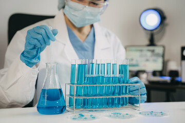 Female scientist researcher conducting an experiment working in the chemical laboratory.