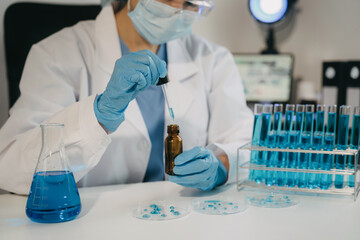 Female scientist researcher conducting an experiment working in the chemical laboratory.