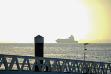 landscape in a seaport. ship leaving the port.