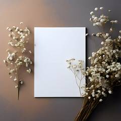 Invitation or greeting card mockup. Blank white card and flowers gypsophila on gray neutral background