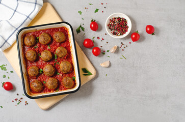 Meatballs in Tomato Sauce, Homemade Meatballs in a Baking Dish on Bright Concrete Background