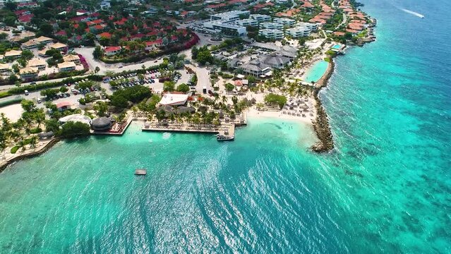 Drone descends to clear turquoise Caribbean waters by Jan Thiel and Zanzibar beach, Curacao