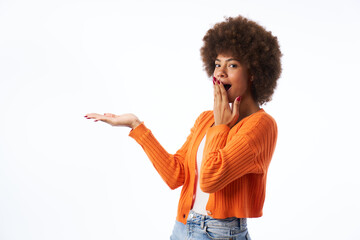 young latina woman with afro hair with surprised gesture points with hand isolated white background