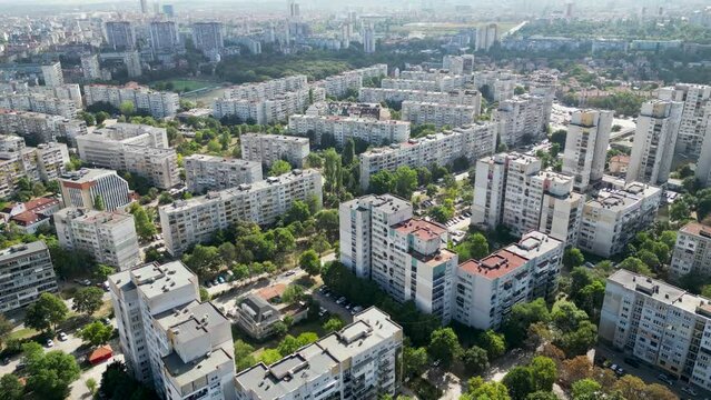 Aerial drone flyover footage of communist era buildings in Eastern Europe. High angle tracking shot of blocks in Sofia Bulgaria. 4k video capturing boring residential buildings from communist times.
