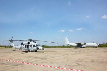 the helicopter and C130 HERCULES military transport aeroplane  parking on run way  prepare to work