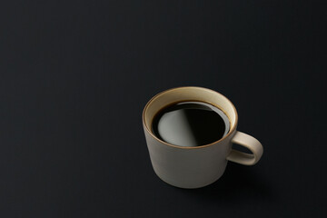 Black coffee and coffee beans on black background